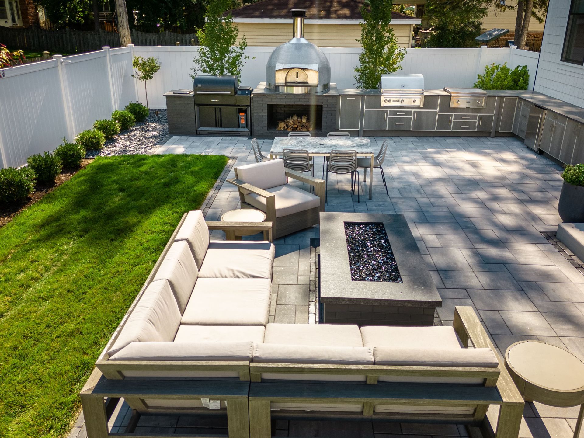 An aerial view of a patio with a fire pit and a couch.