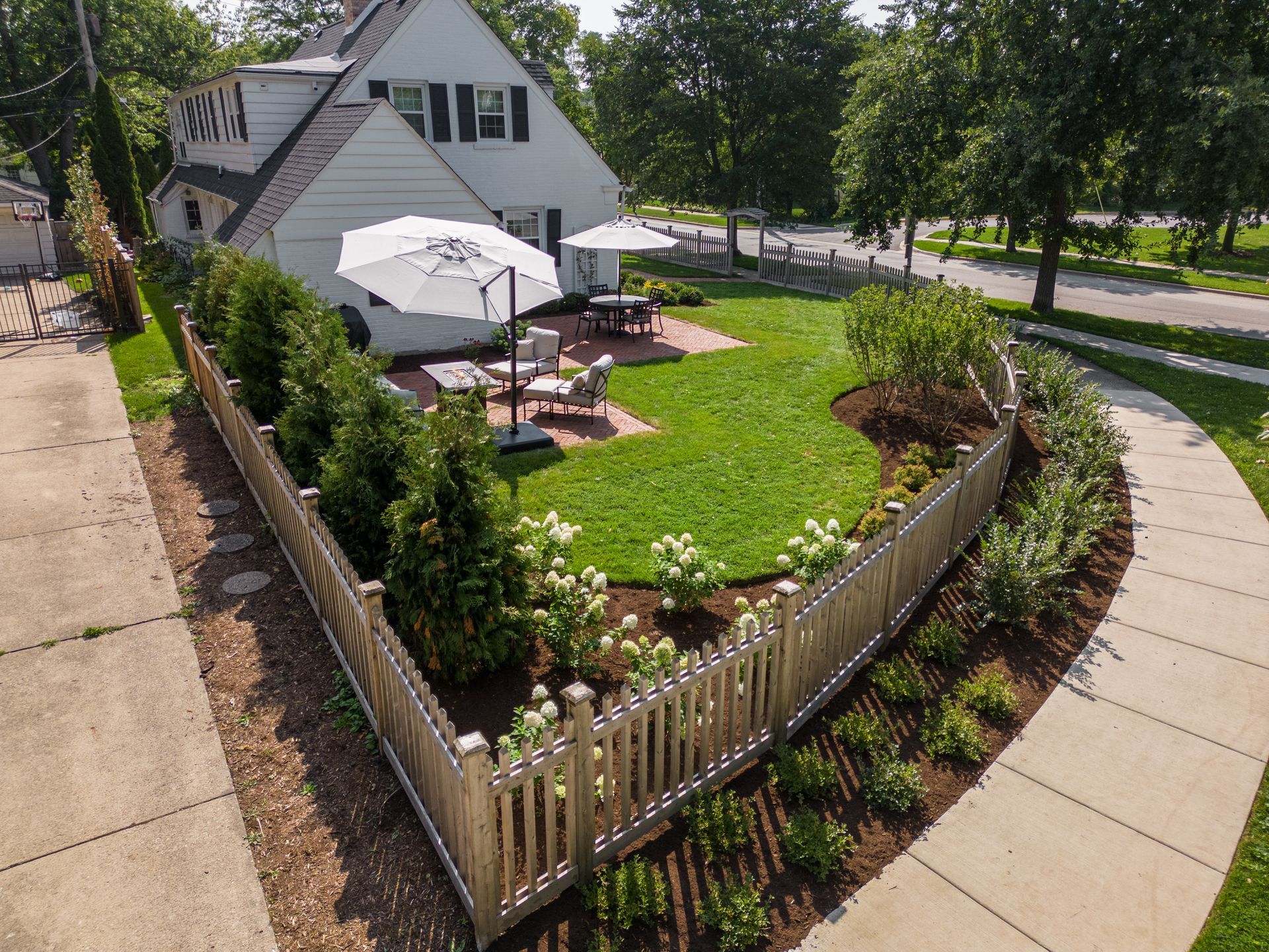 An aerial view of a house with a fence around it