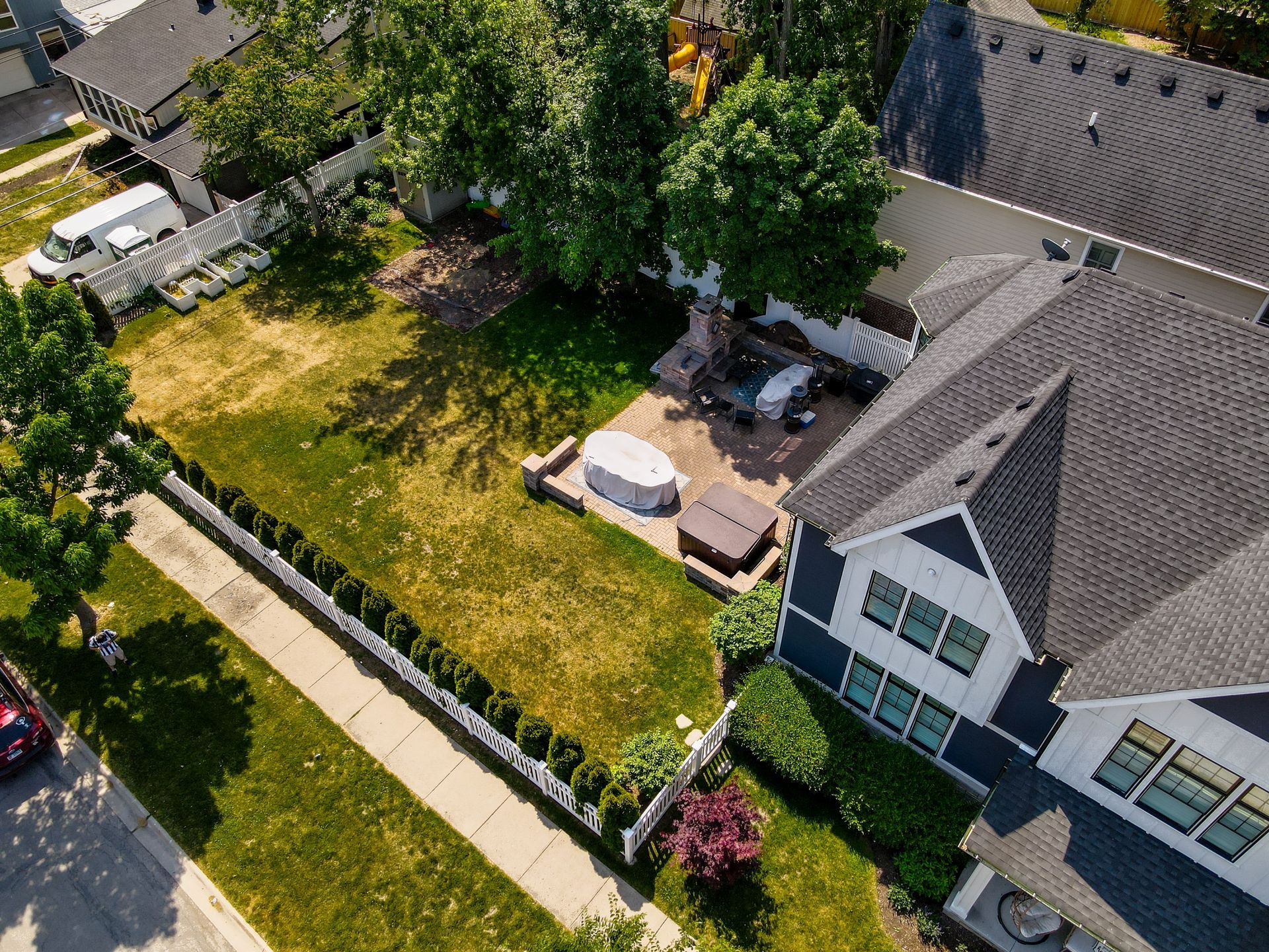 An aerial view of a house with a hot tub in the backyard.