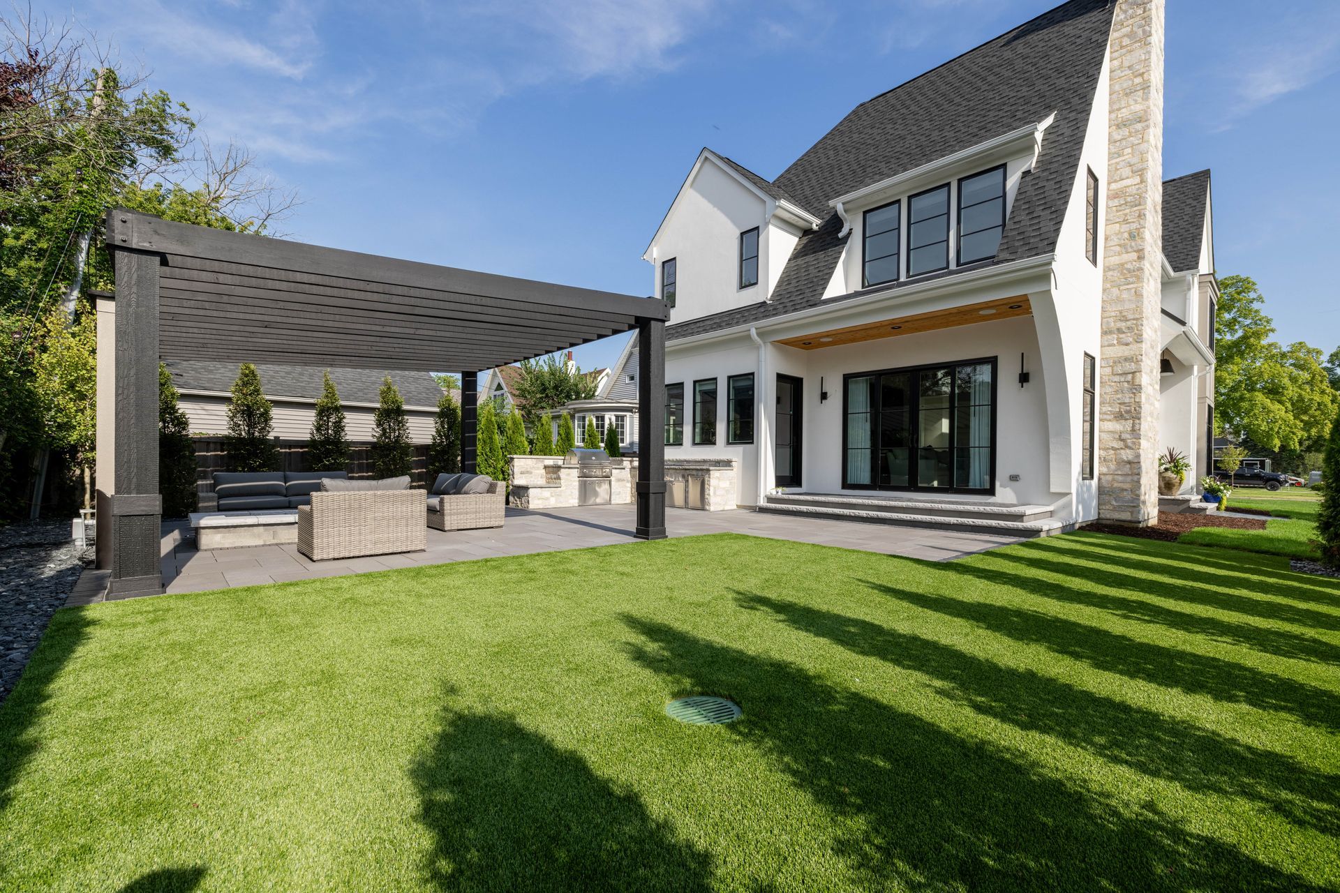 A large white house with a large lawn in front of it.