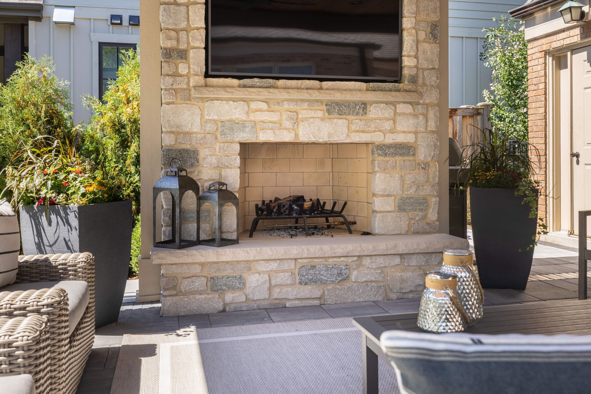 A brick fireplace with a flat screen tv mounted above it.