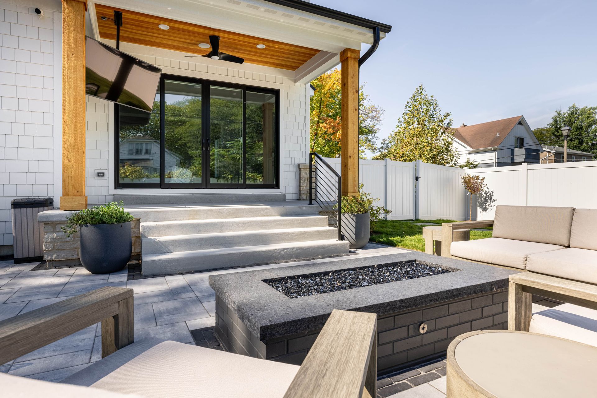 There is a fire pit in the backyard of a house.