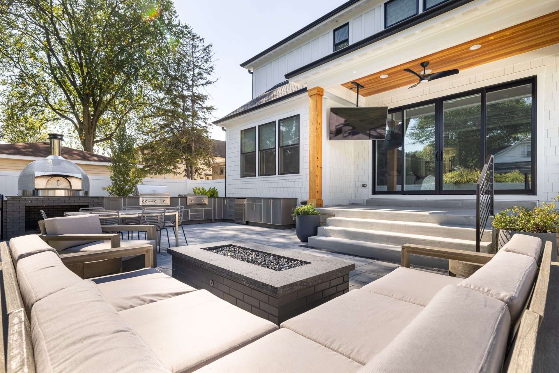 There is a fire pit in the backyard of a house.