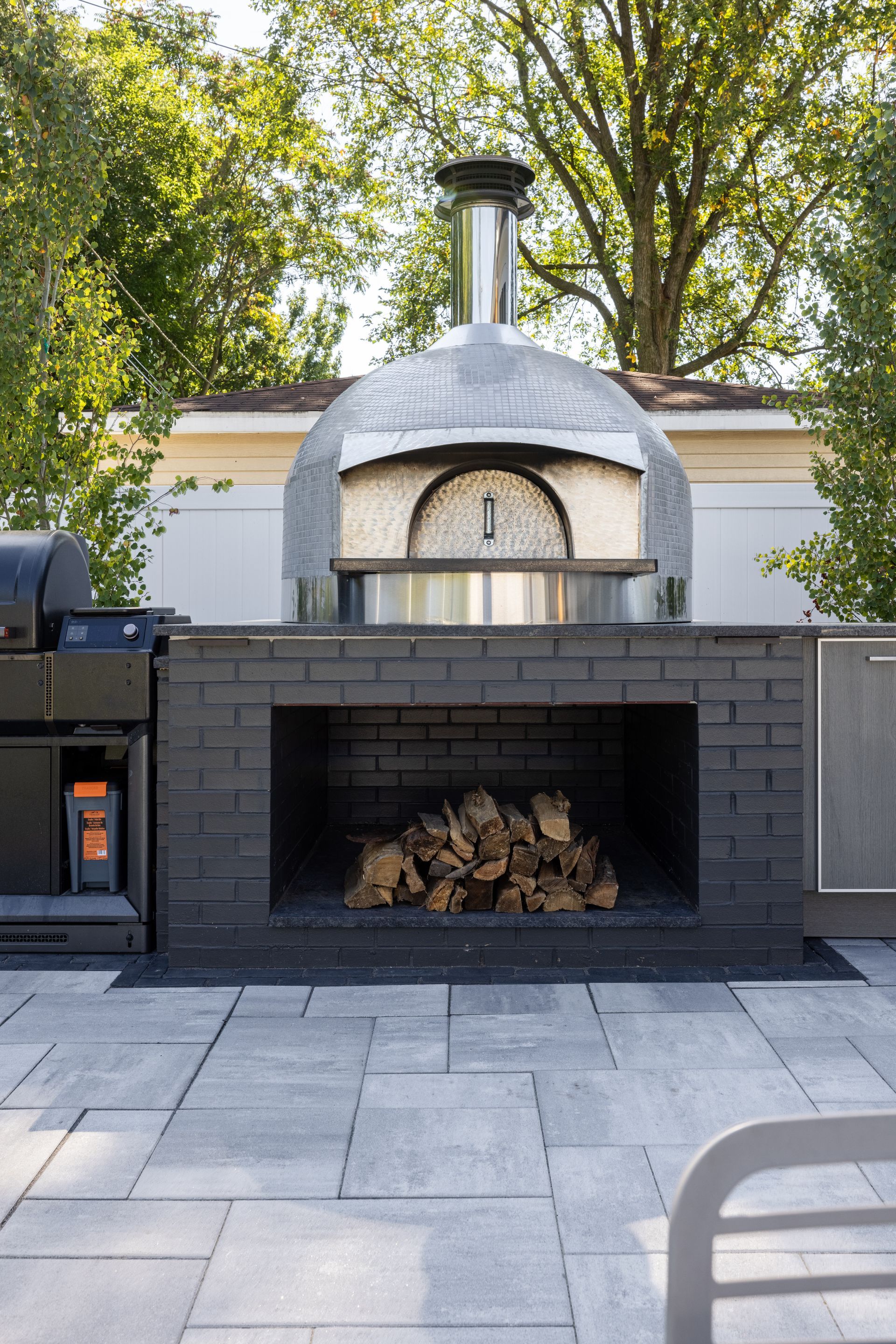 A pizza oven is built into a brick fireplace.