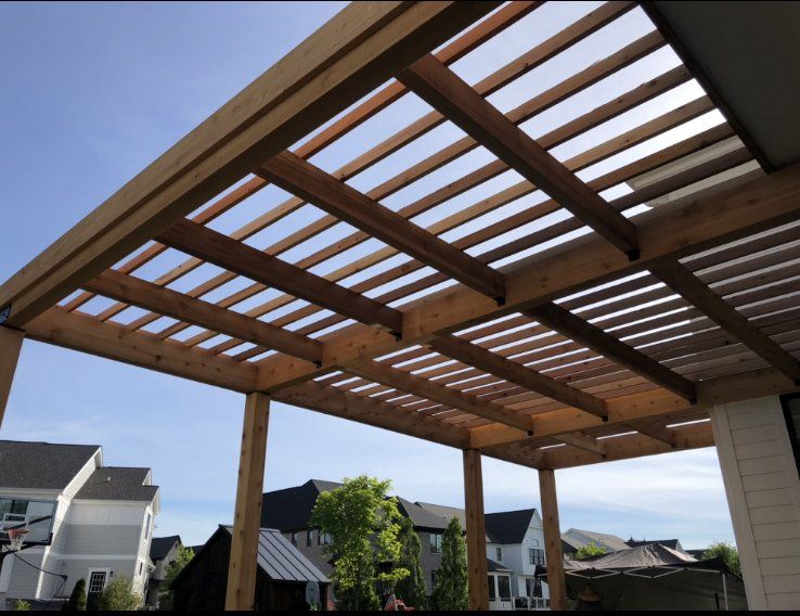 A wooden pergola with a blue sky in the background