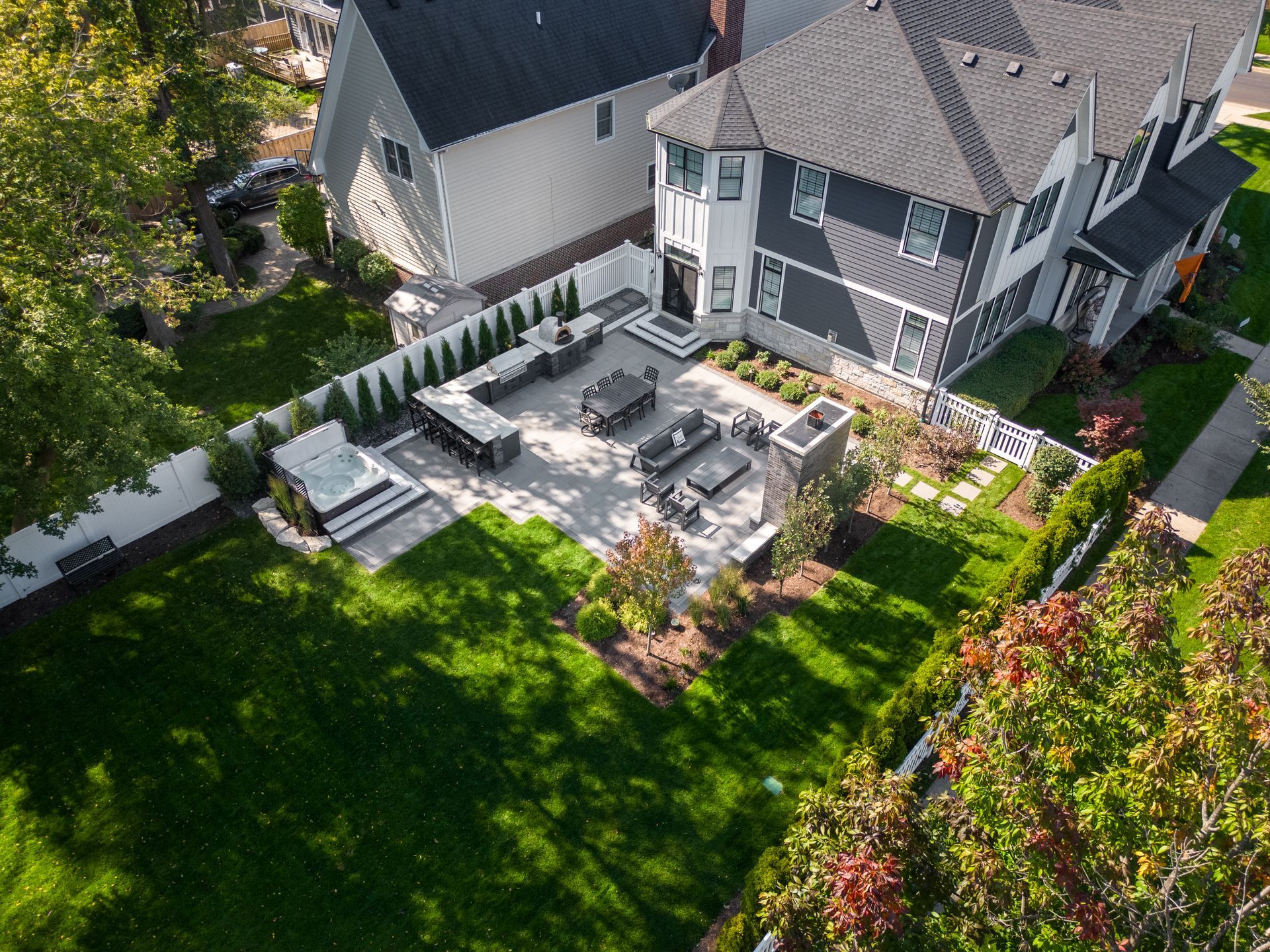 An aerial view of a house with a patio area in front of it.