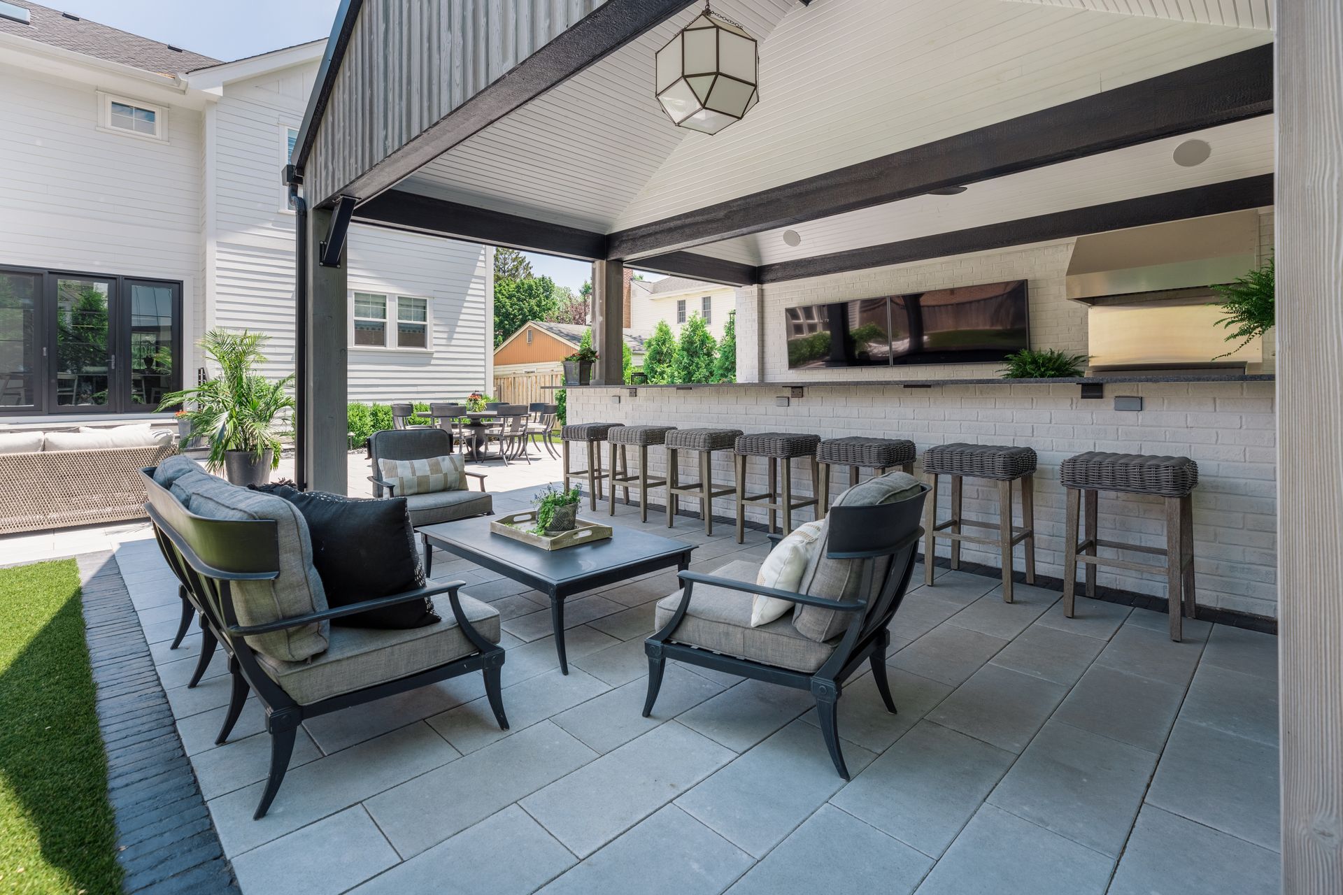 A patio with a table and chairs under a canopy.