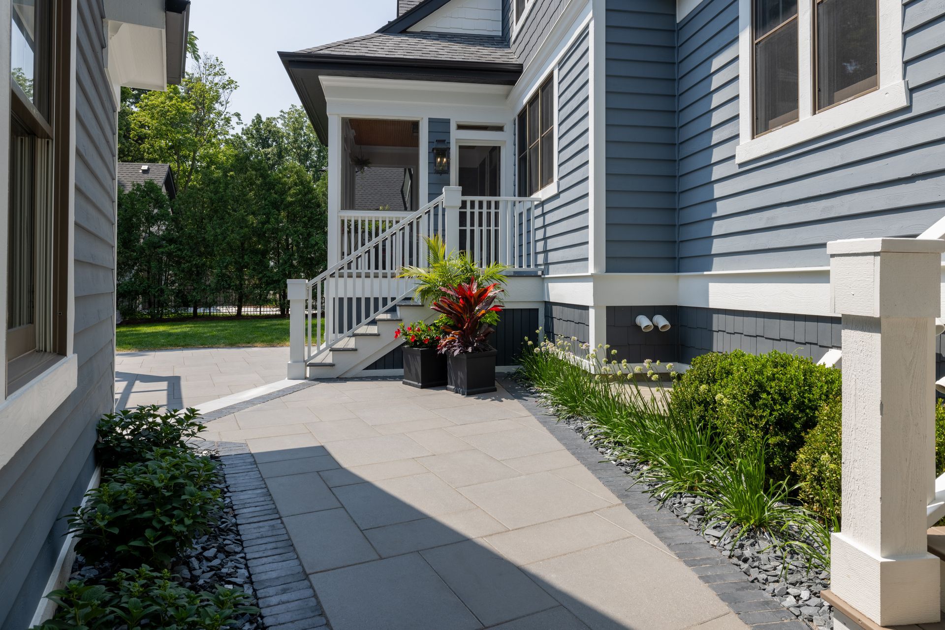 There is a walkway leading to the front of the house.
