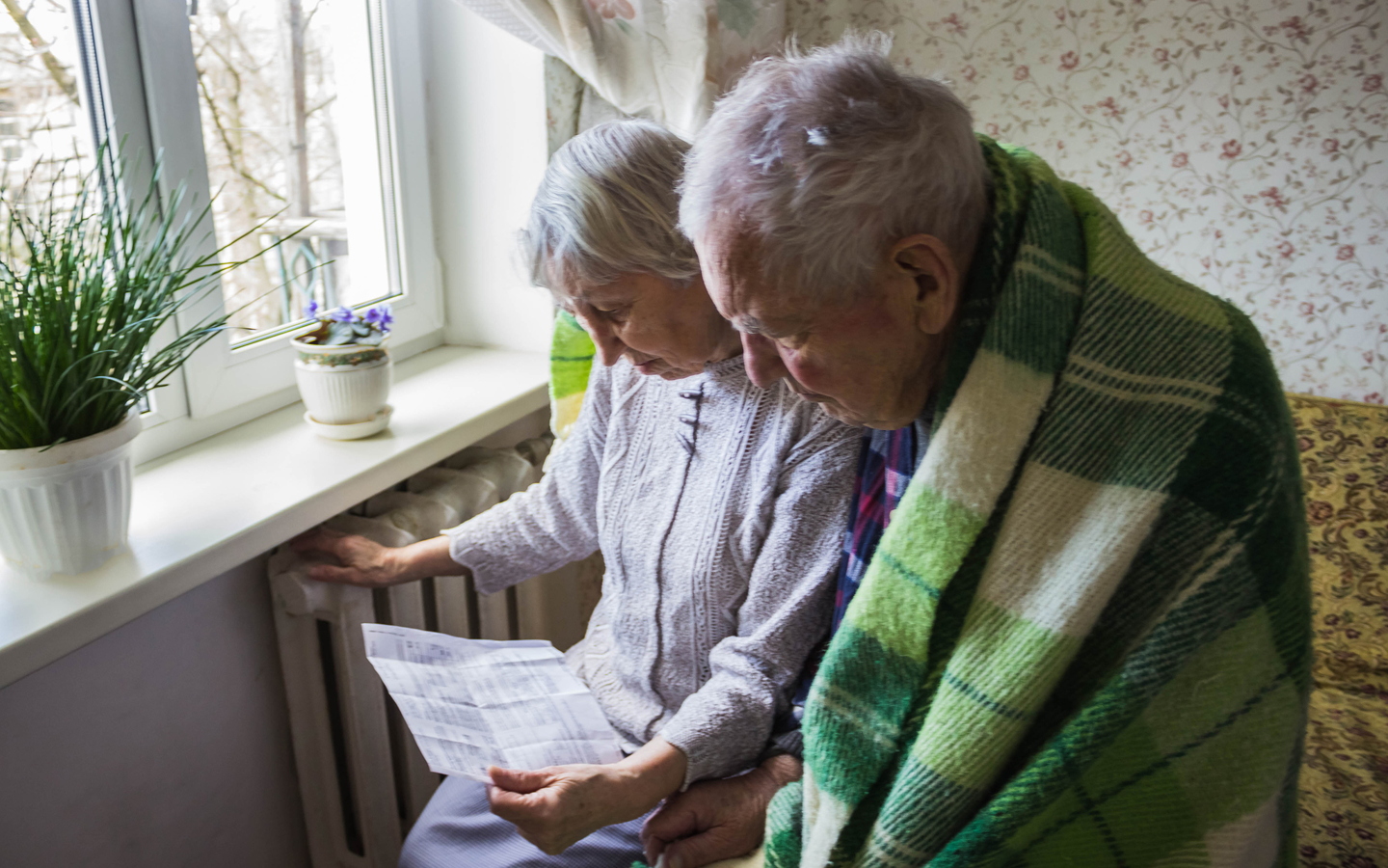 Elderly couple reviewing energy bill