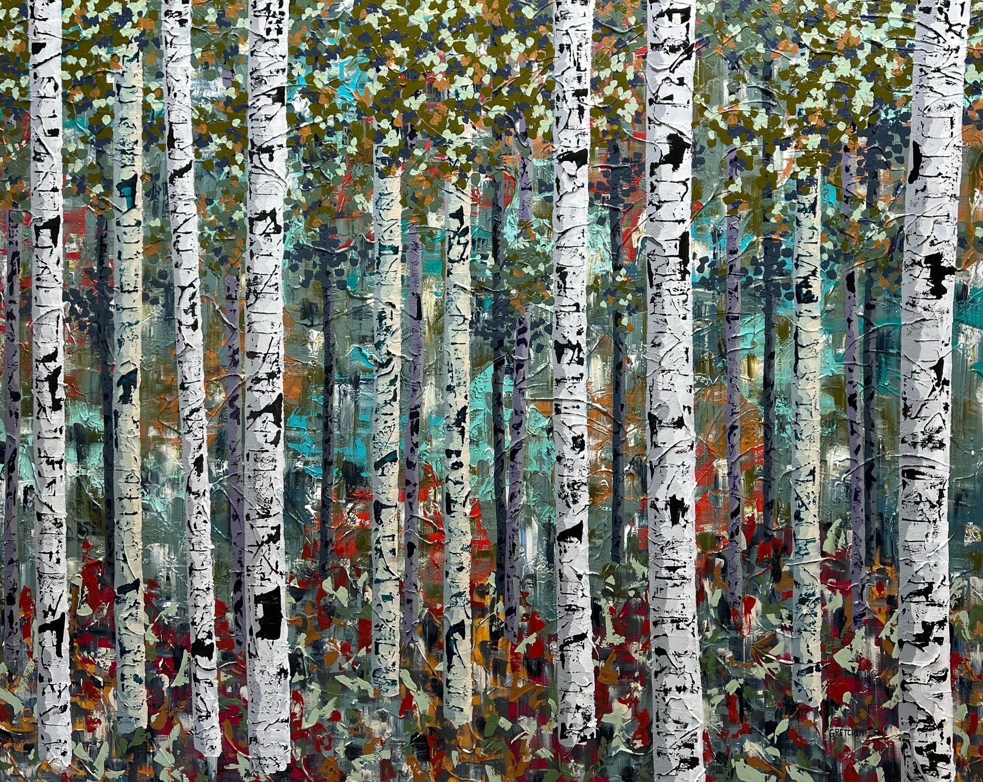 Birch trees with white bark and black markings in a colorful forest.