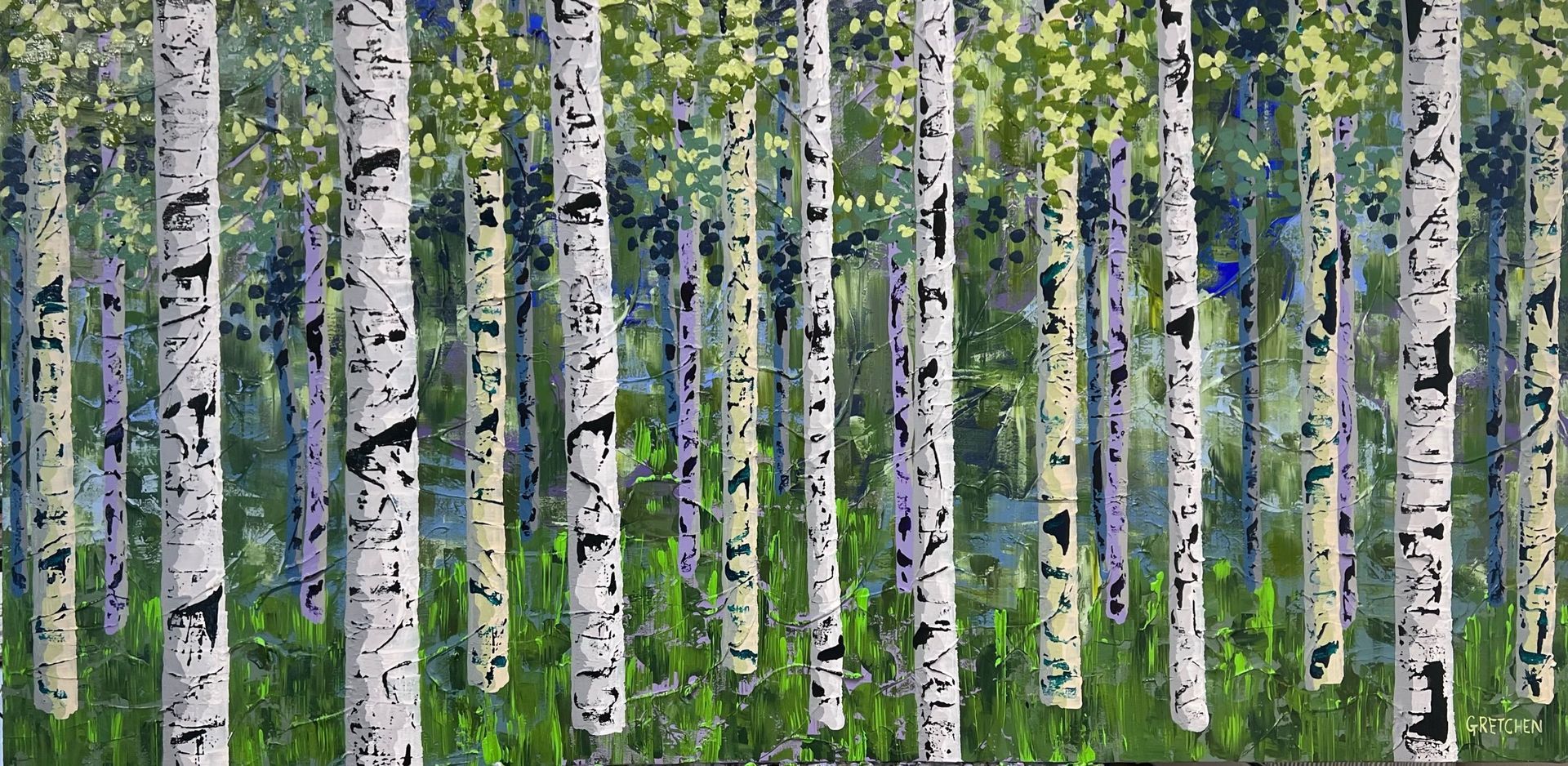 Aspen trees with white trunks and black markings in a green meadow.