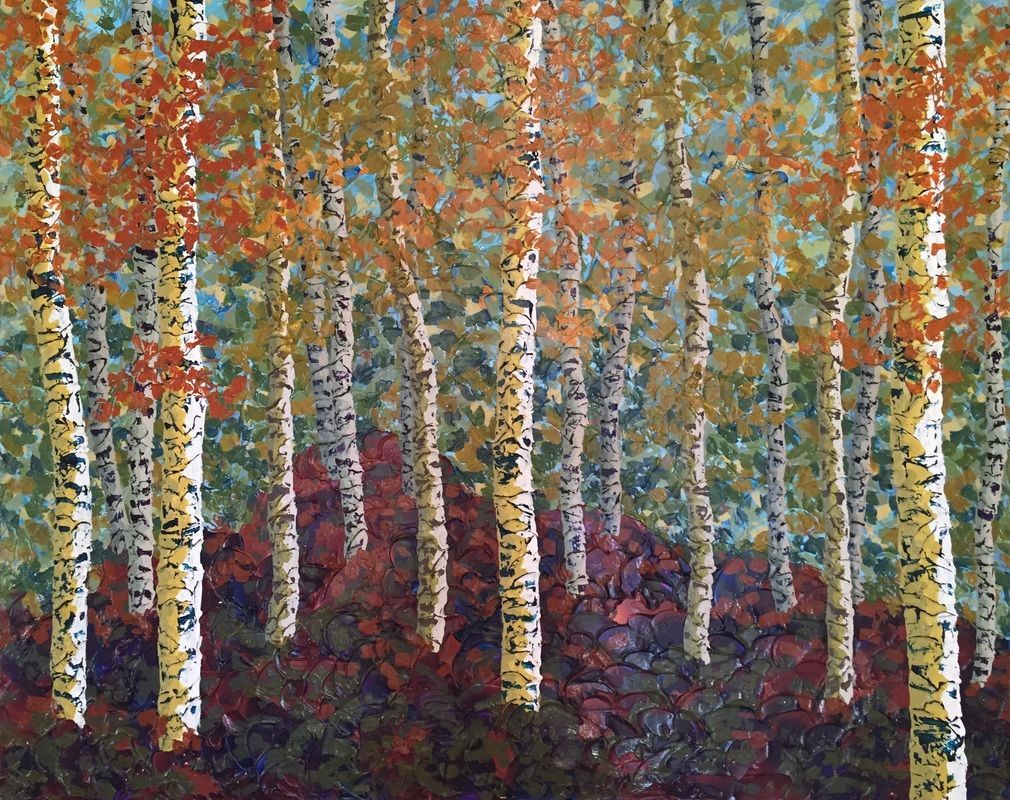 Birch trees with autumn leaves in varying shades of orange and yellow.
