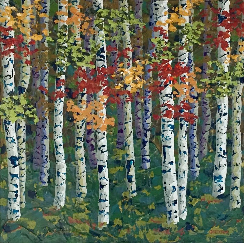Birch trees with white trunks and colorful autumn leaves; green forest floor.