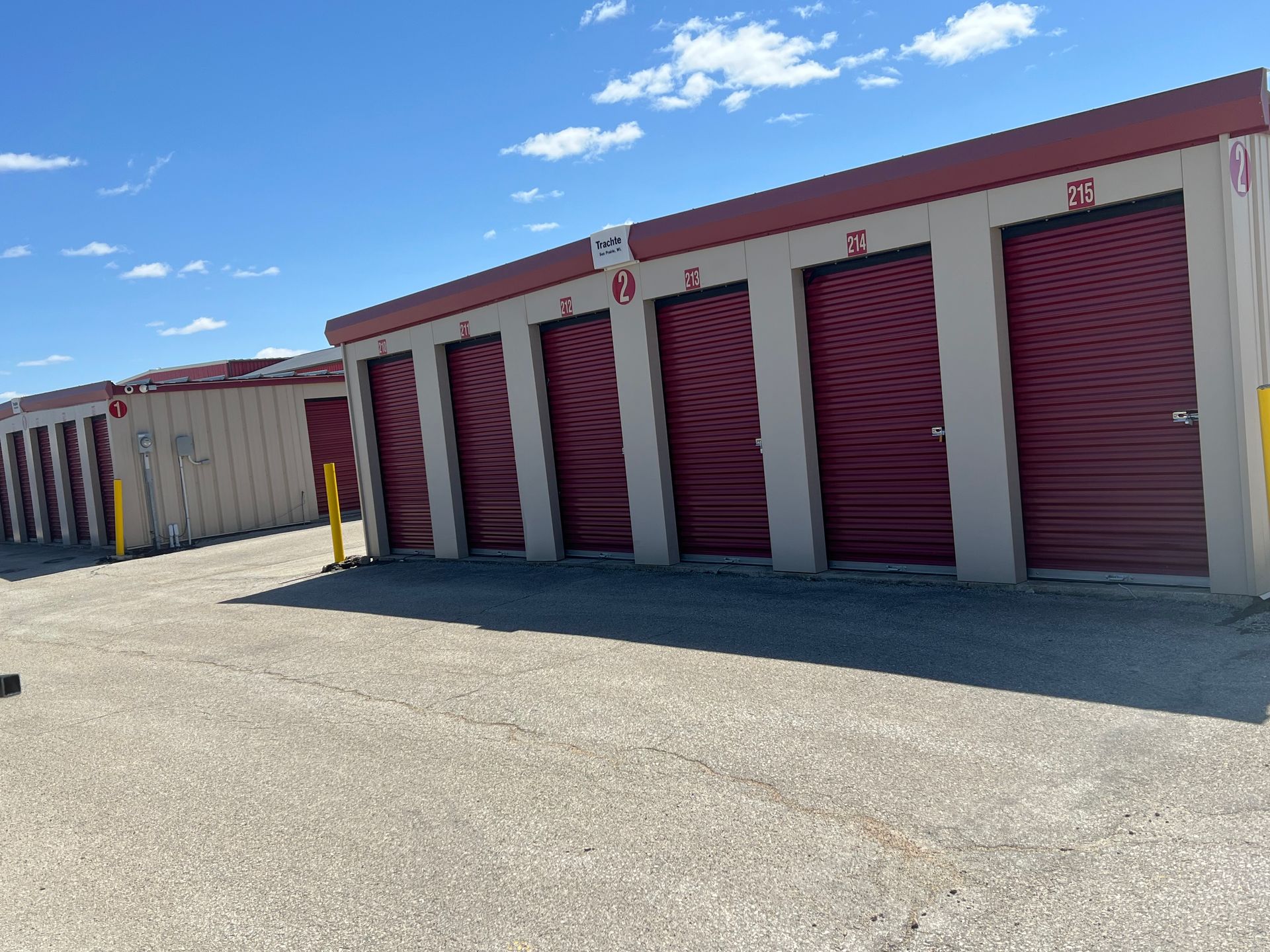 A Row of Storage Units With a Bicycle and a Soccer Ball