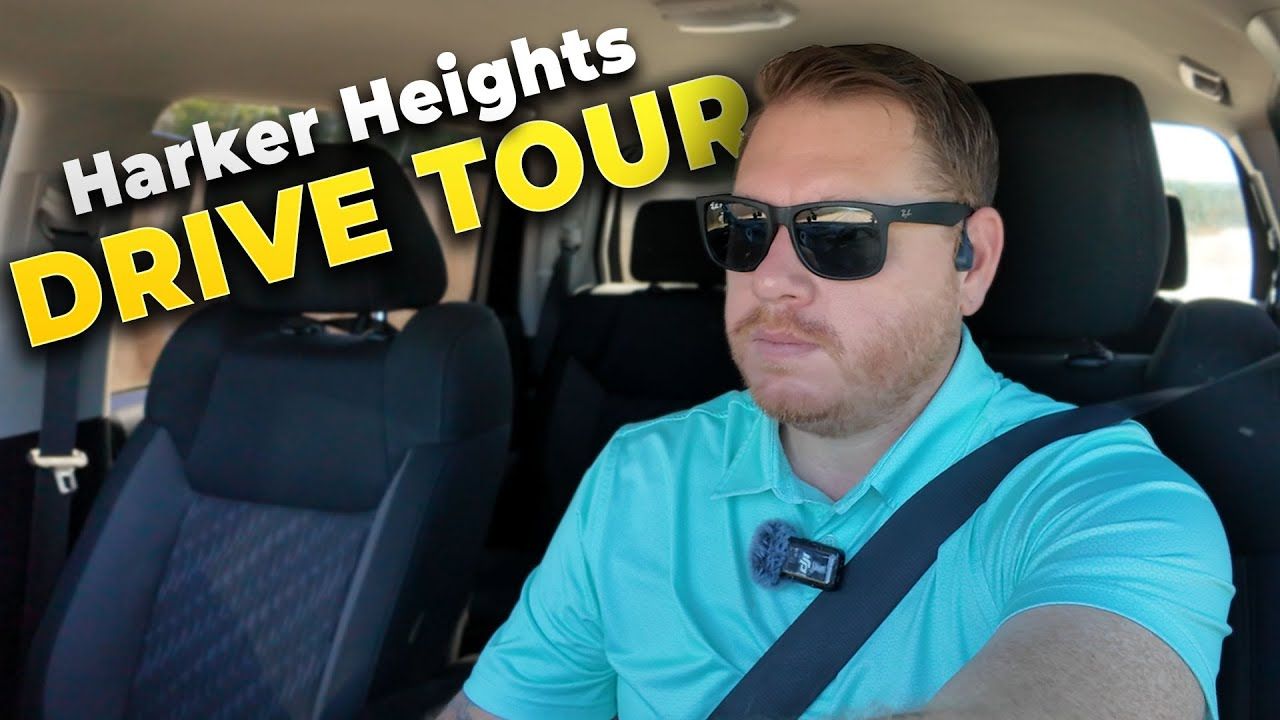 Man driving in Harker Heights, wearing sunglasses and a teal shirt.