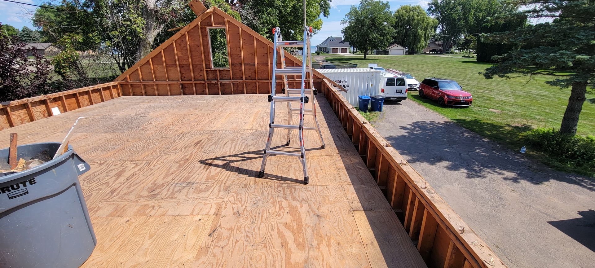 A ladder is sitting on top of a wooden deck.