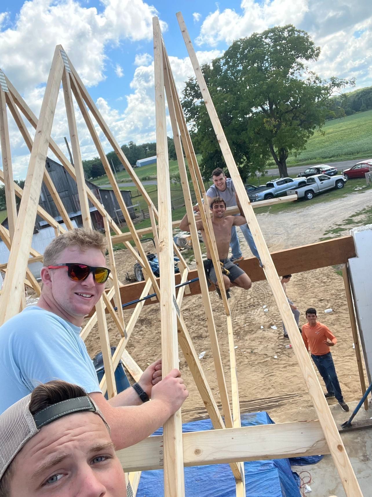 A group of men are working on a wooden structure.