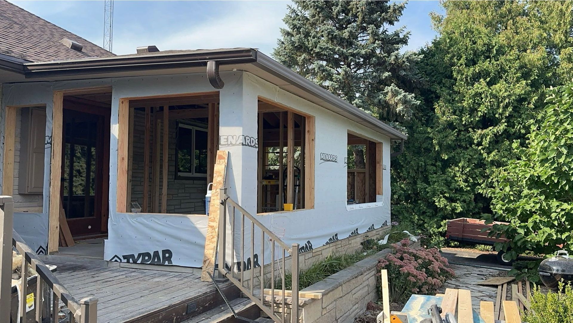 A house is being remodeled with a lot of windows and stairs.