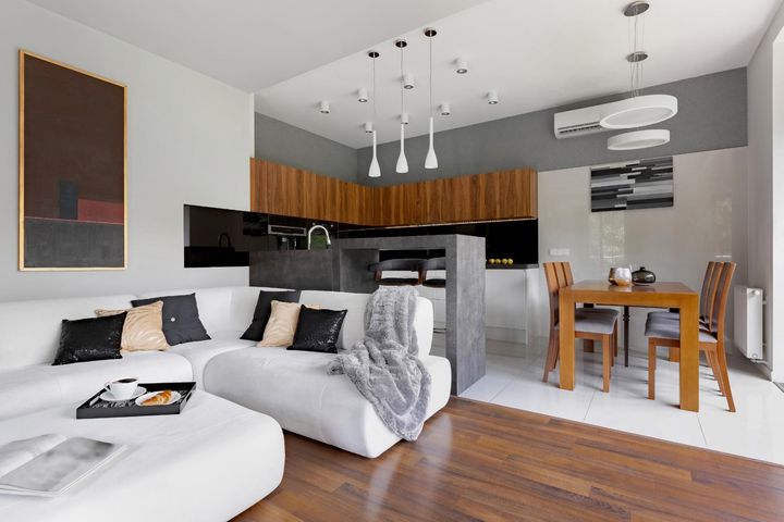A living room with a couch, table and chairs.