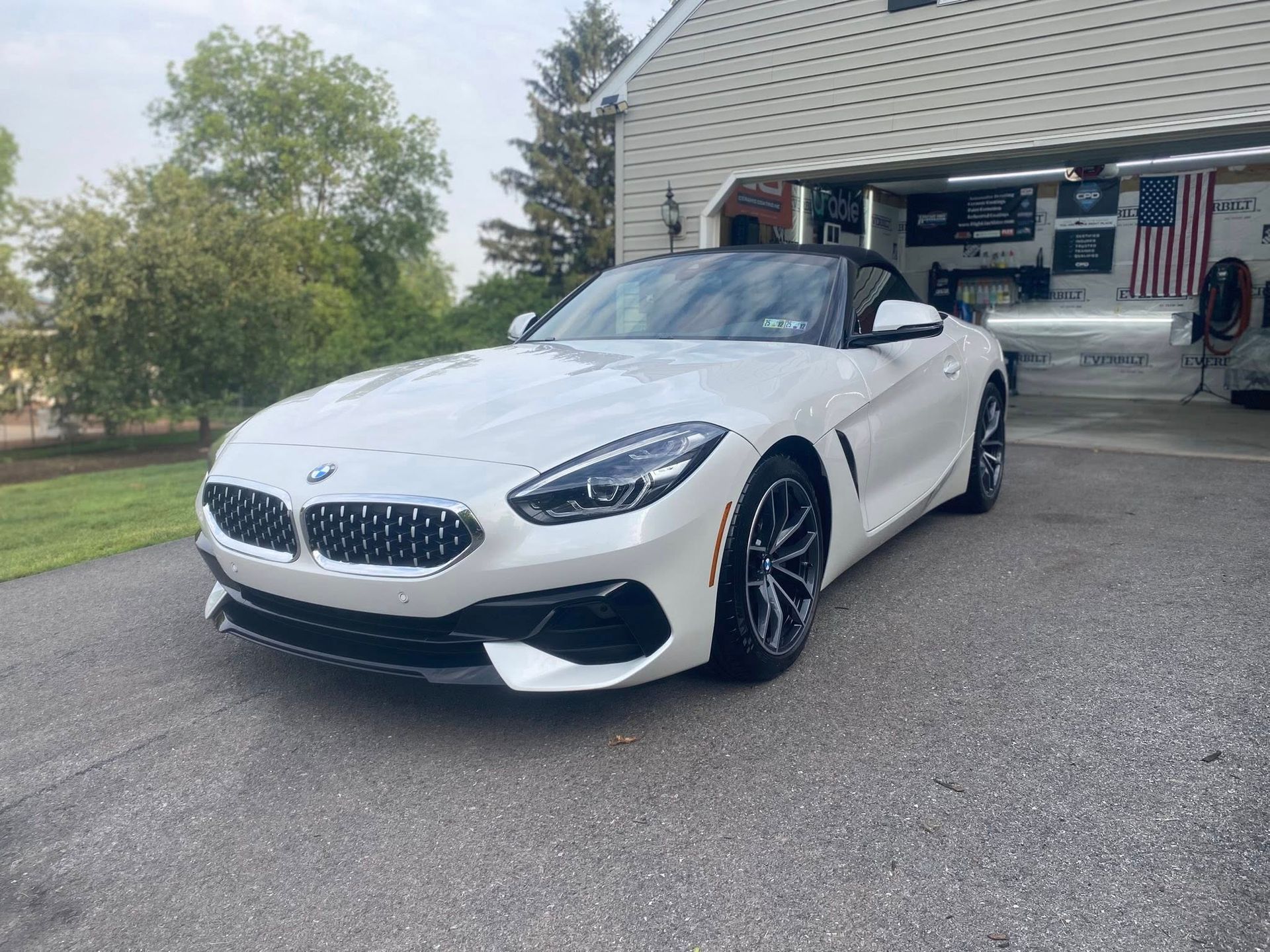 Silver Toyota TRD Pro truck parked indoors. Black wheels and trim, American flag in background.
