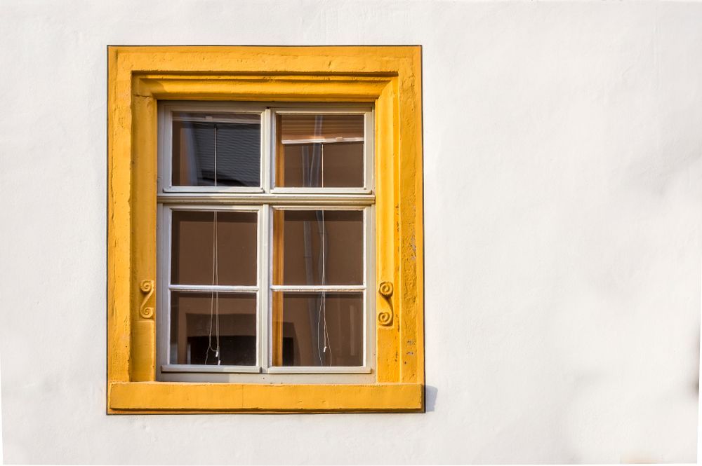 A Yellow Window With A White Frame Is On A White Wall — Roo’s Door & Window Maintenance In Sippy Downs, QLD