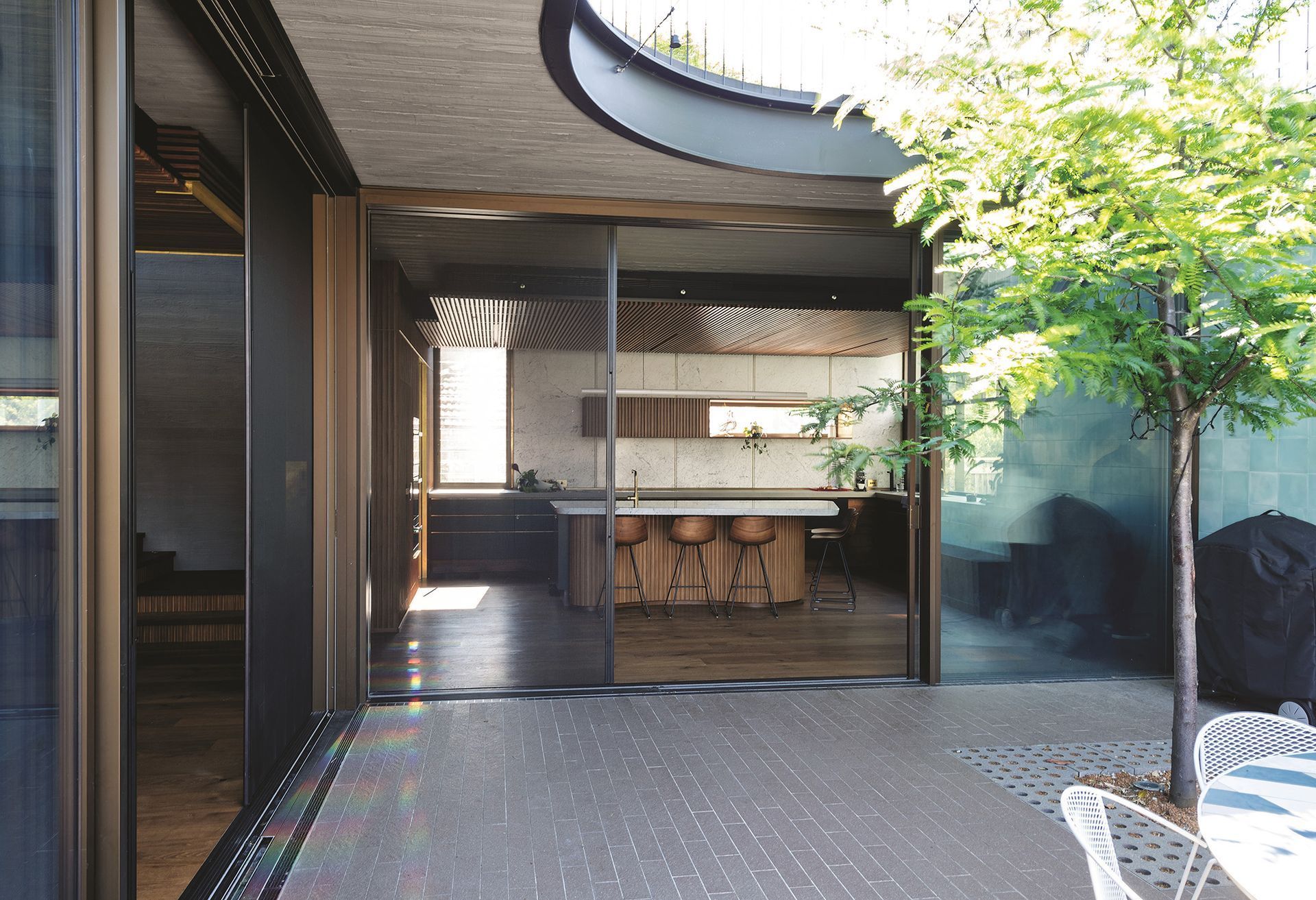 A View Of A Kitchen From A Patio With Sliding Glass Doors — Roo’s Door & Window Maintenance In Sippy Downs, QLD