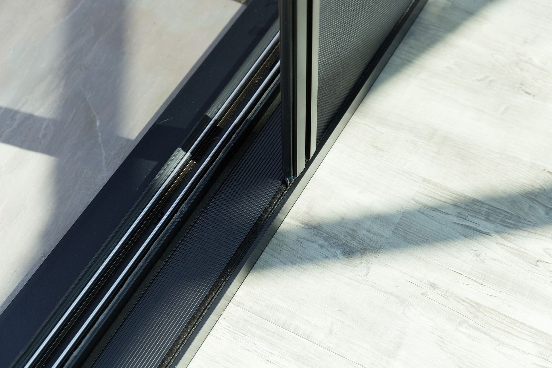A Close Up Of A Sliding Glass Door On A Tiled Floor — Roo’s Door & Window Maintenance In Sippy Downs, QLD