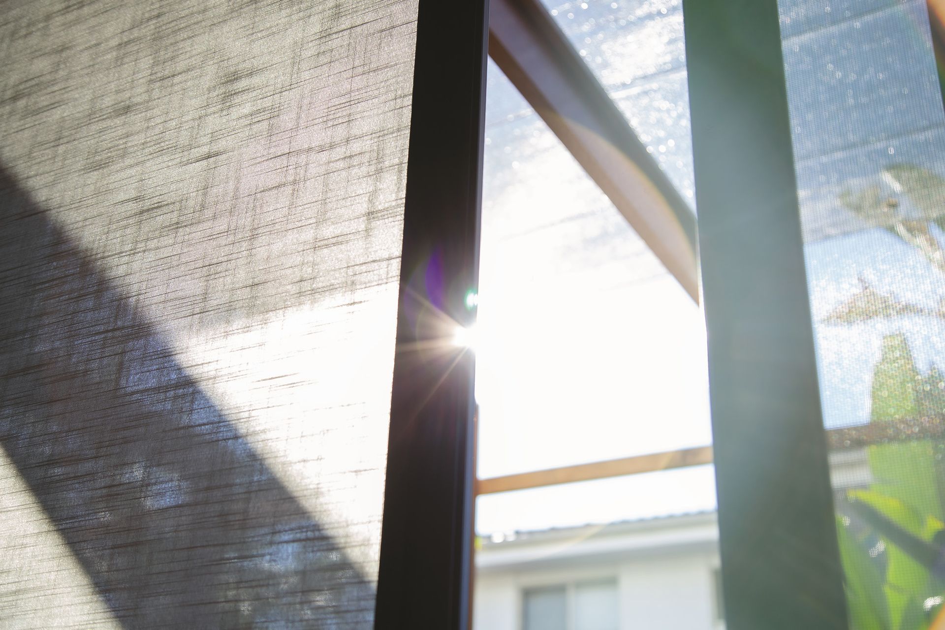 The Sun Is Shining Through The Blinds Of A Window — Roo’s Door & Window Maintenance In Sippy Downs, QLD