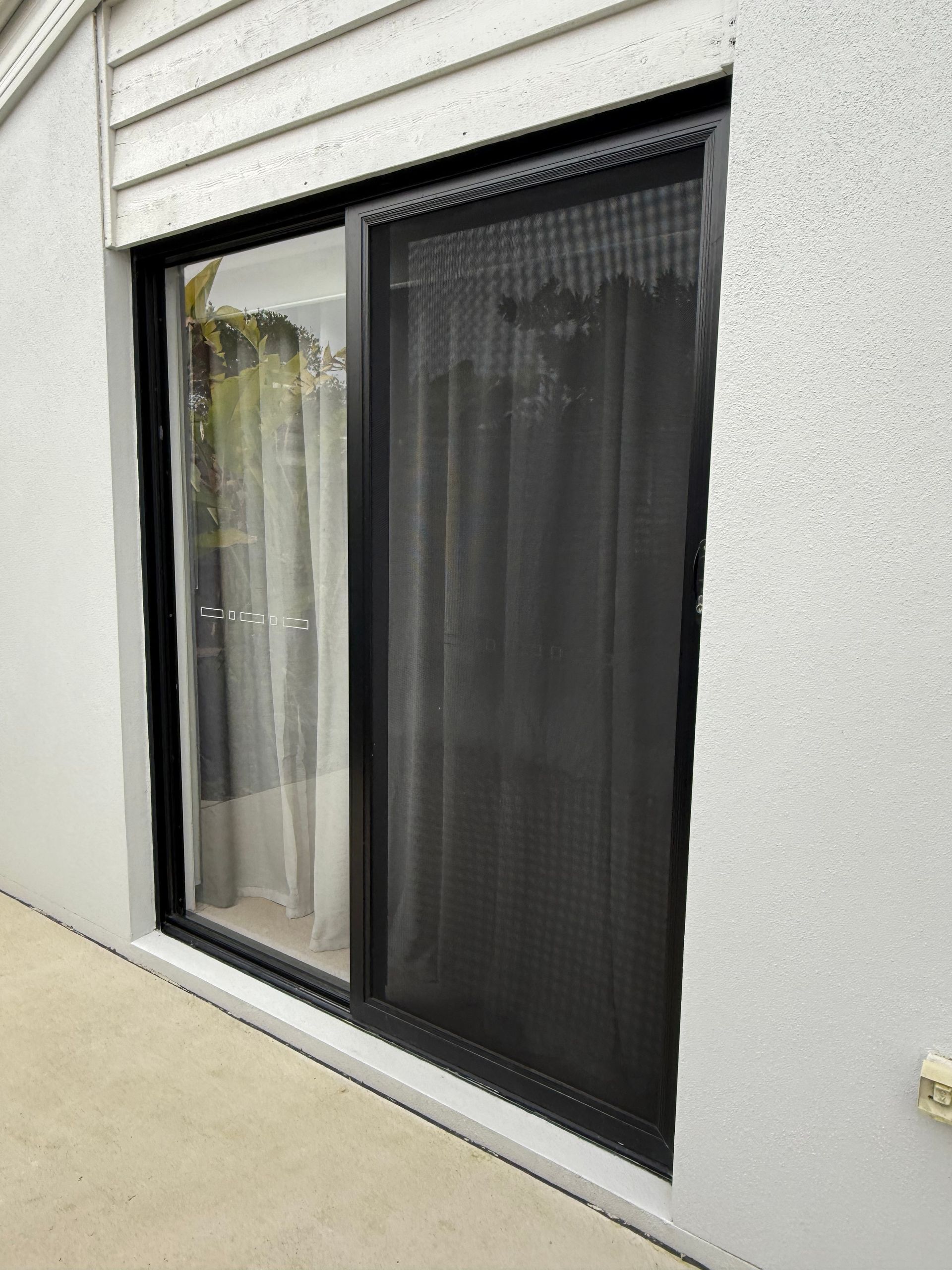 A Person Is Holding A Mosquito Screen On A Window — Roo’s Door & Window Maintenance In Sippy Downs, QLD