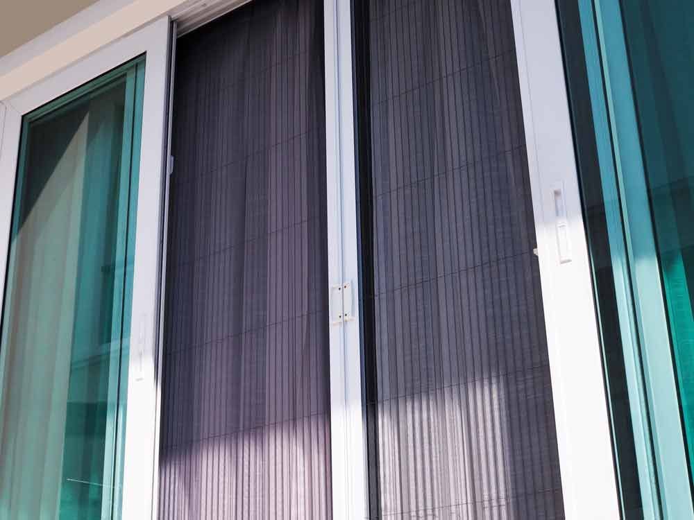 A Close Up Of A Sliding Glass Door With A Screen On It — Roo’s Door & Window Maintenance In Sippy Downs, QLD