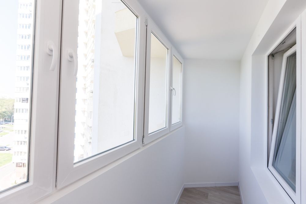 A Balcony With A Lot Of Windows In A Building — Roo’s Door & Window Maintenance In Sippy Downs, QLD