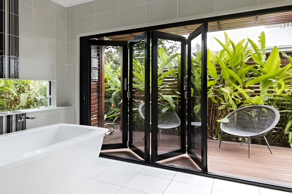 A Bathroom With A Sliding Glass Doors Leading To A Patio — Roo’s Door & Window Maintenance In Sippy Downs, QLD