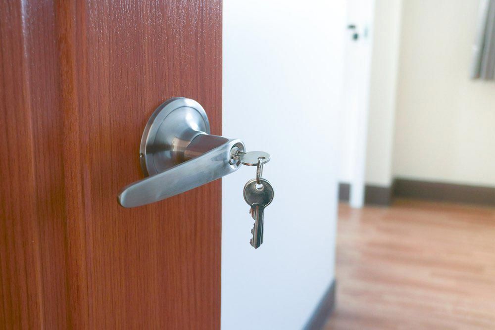 A Close Up Of A Door With A Key In The Lock — Roo’s Door & Window Maintenance In Maroochydore, QLD