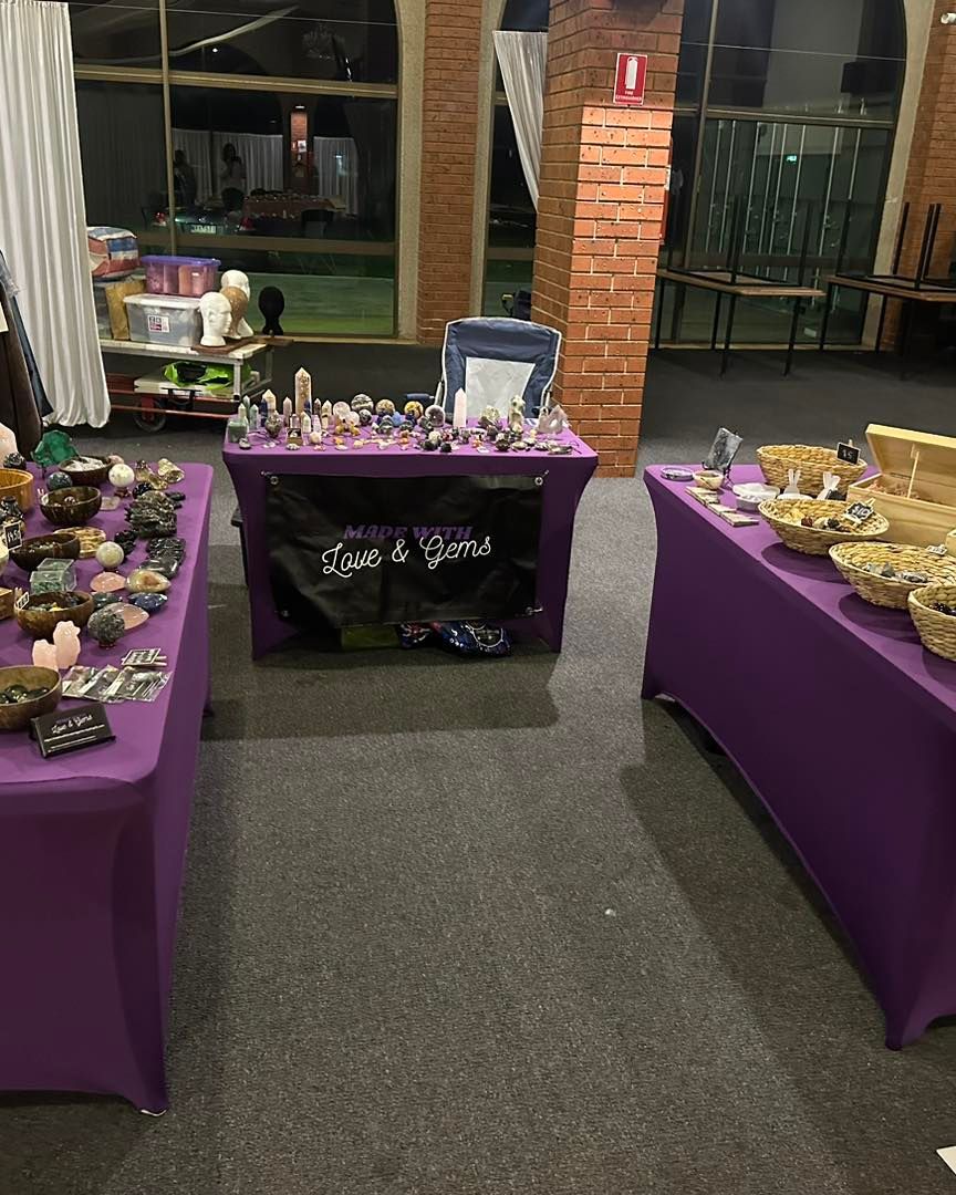 A room with two purple tables filled with various items.