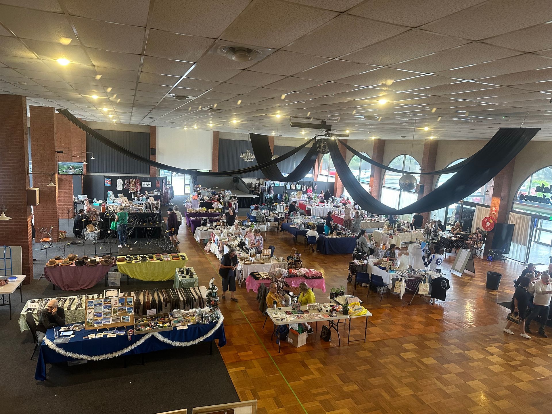 An aerial view of a large room filled with tables and chairs.