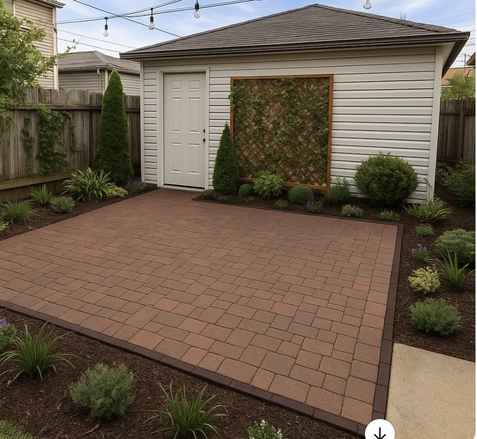 Brick patio with garden beds, a white garage, and string lights.