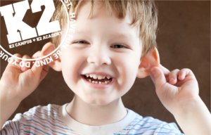 A child covering his ears with a k2 logo