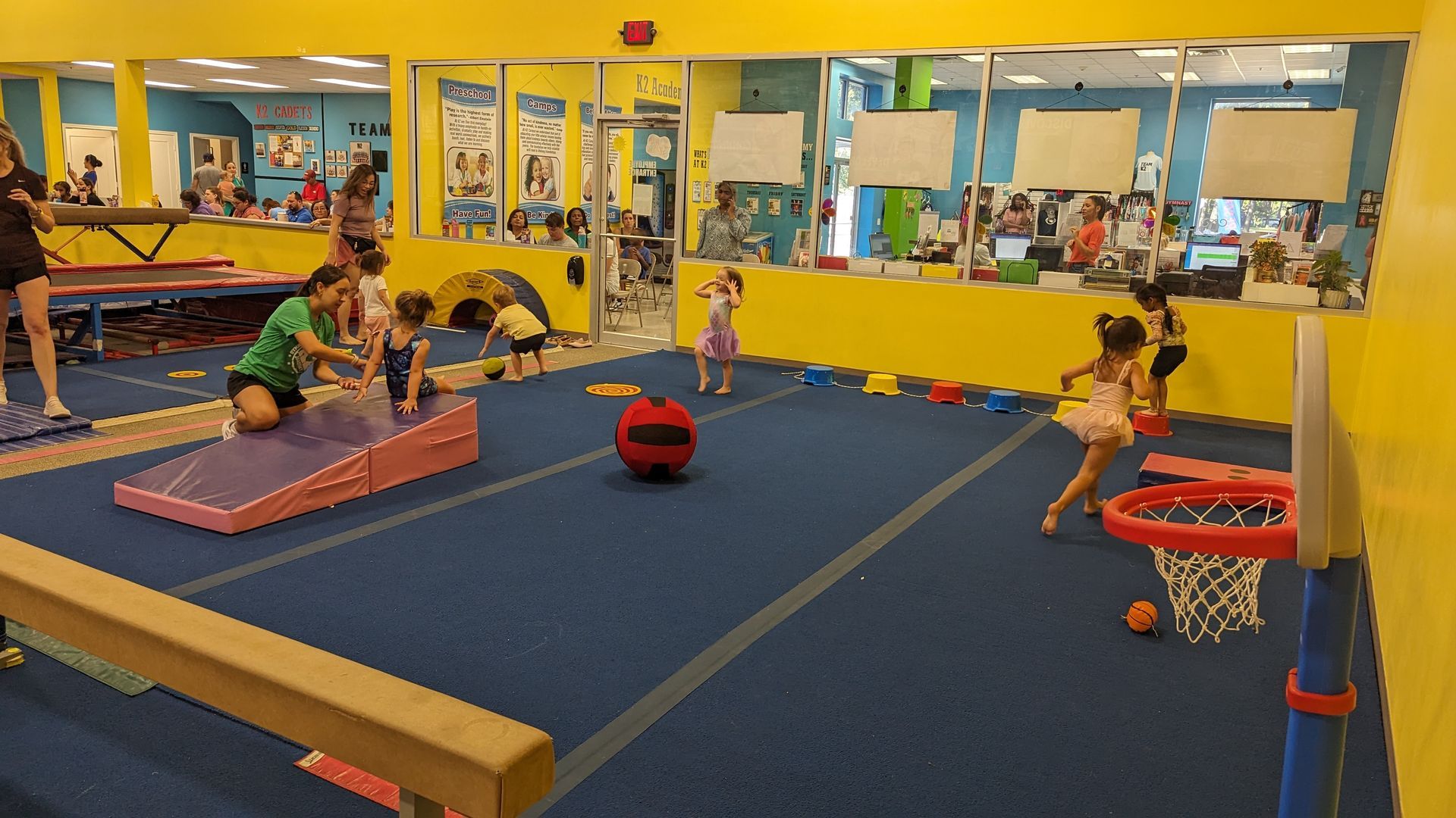 A group of children are playing in a gym.