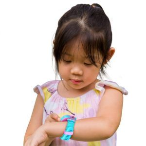 A little girl is wearing a smart watch on her wrist.