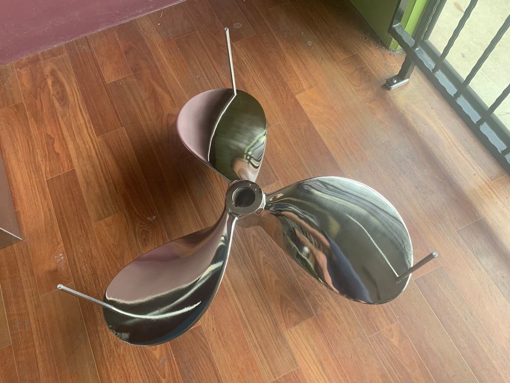 A Stainless Steel Propeller is Sitting on a Wooden Floor — Metaltrendz in Buderim, QLD