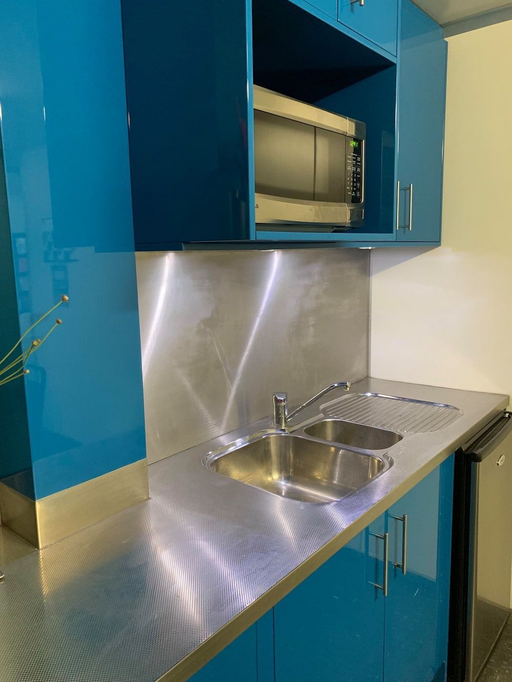 A Kitchen With Blue Cabinets and Stainless Steel Counter Tops — Metaltrendz in Kunda Park, QLD