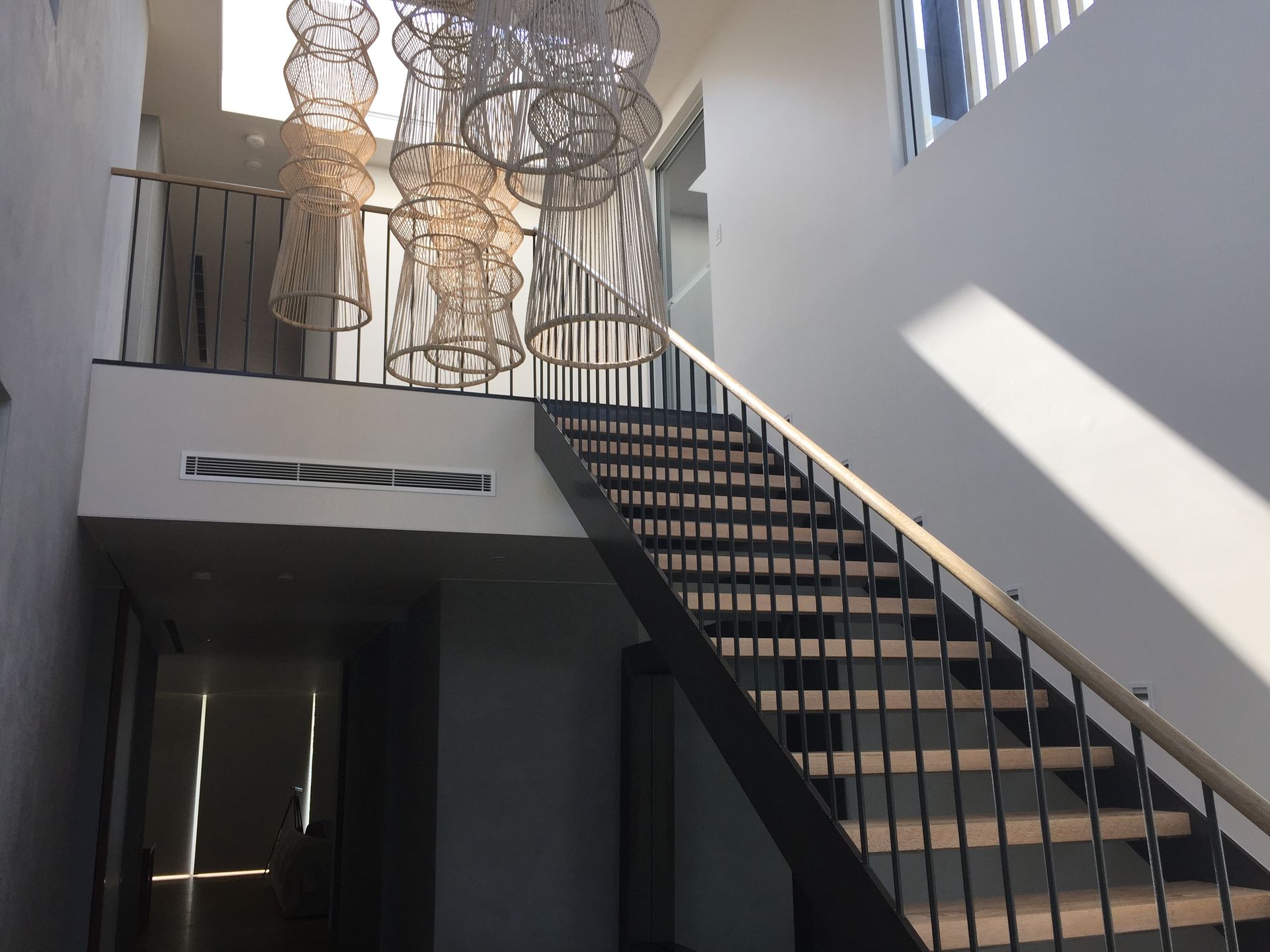 Staircase inside a bright white building with metal railings, leading to a second level — Metaltrendz in Kunda Park, QLD