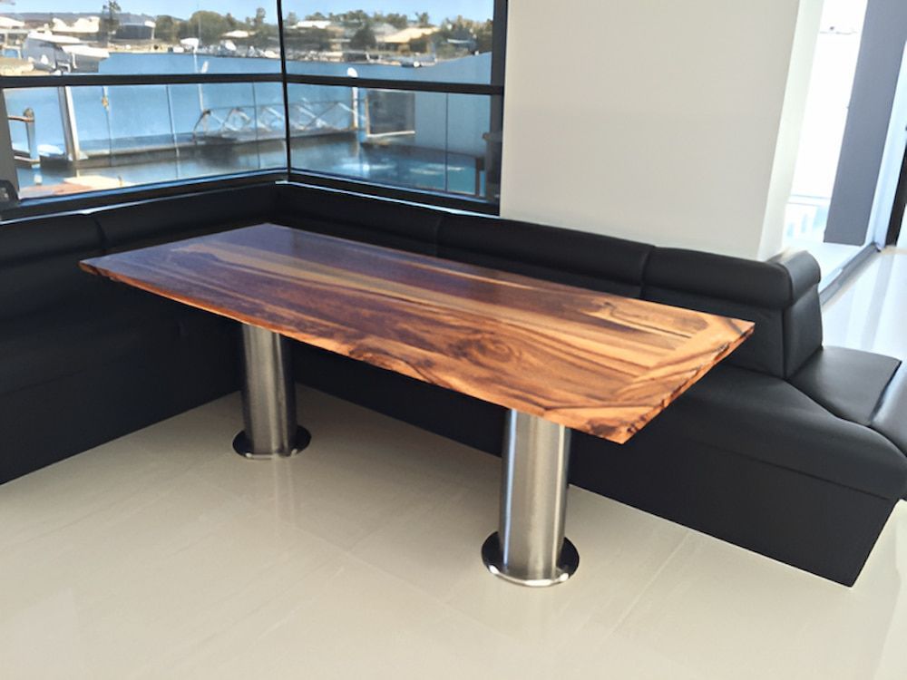 A Wooden Table is Sitting in a Corner of a Room Next to a Window — Metaltrendz in Kunda Park, QLD