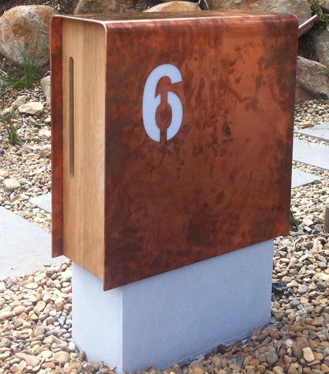 Copper mailbox with the number 6, mounted on a gray concrete base, surrounded by gravel — Metaltrendz in Kunda Park, QLD