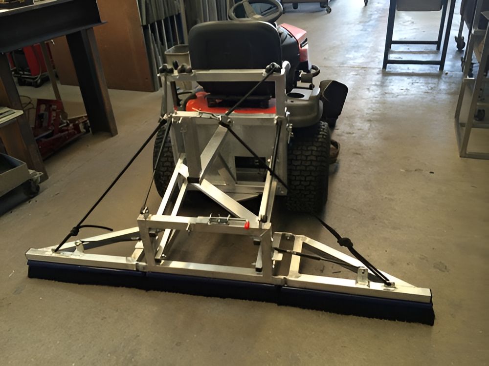 A Lawn Mower With a stainless steel Broom Attached to It — Metaltrendz in Coolum Beach, QLD