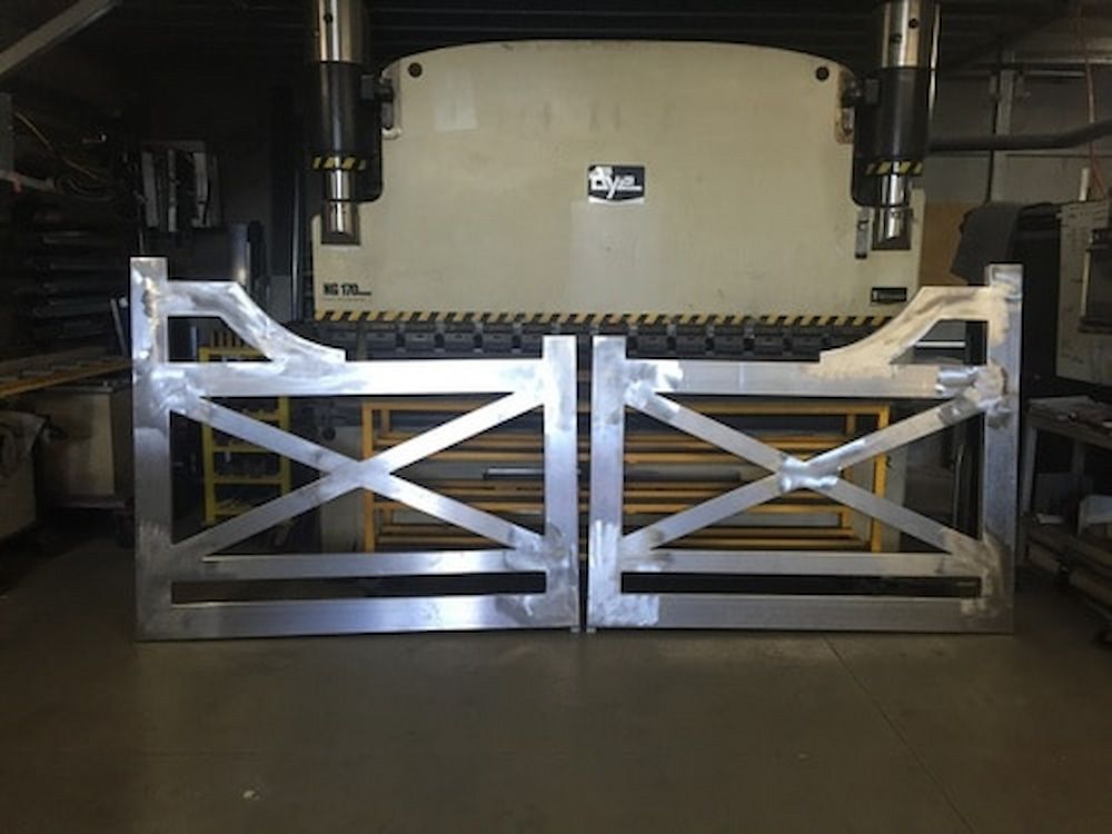 A Pair of Metal Gates Are Sitting in Front of a Machine — Metaltrendz in Coolum Beach, QLD