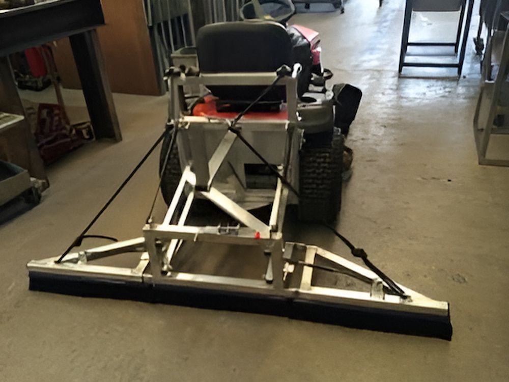 A Lawn Mower With a stainless steel Broom Attached to It — Metaltrendz in Kunda Park, QLD