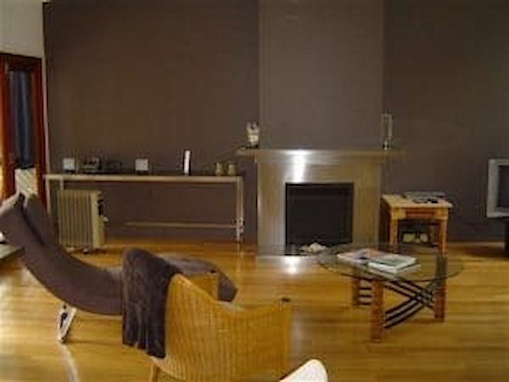 A Living Room With a Fireplace and a Chair — Metaltrendz in Kunda Park, QLD