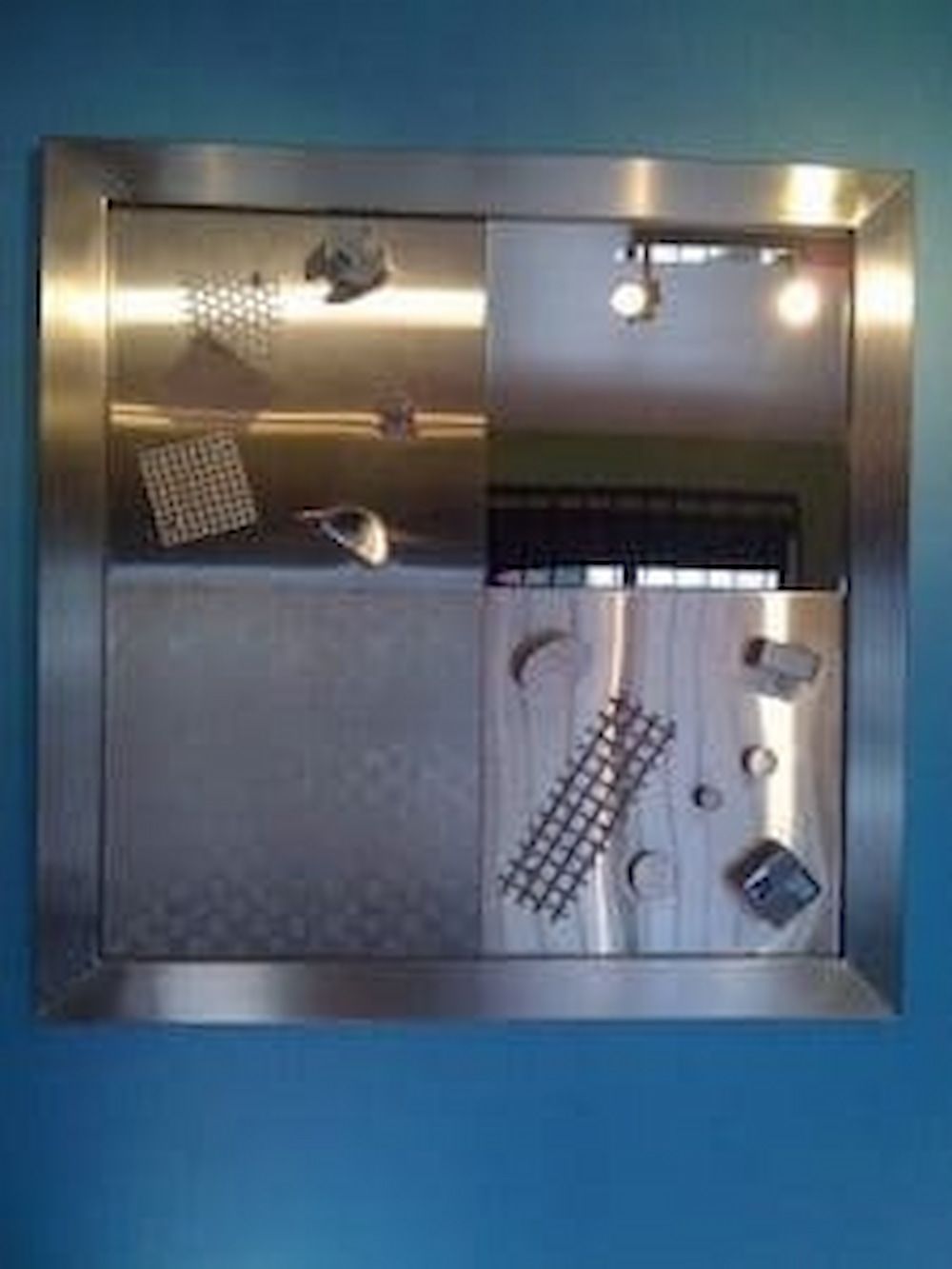 A Stainless Steel Mirror is Hanging on a Blue Wall — Metaltrendz in Kunda Park, QLD