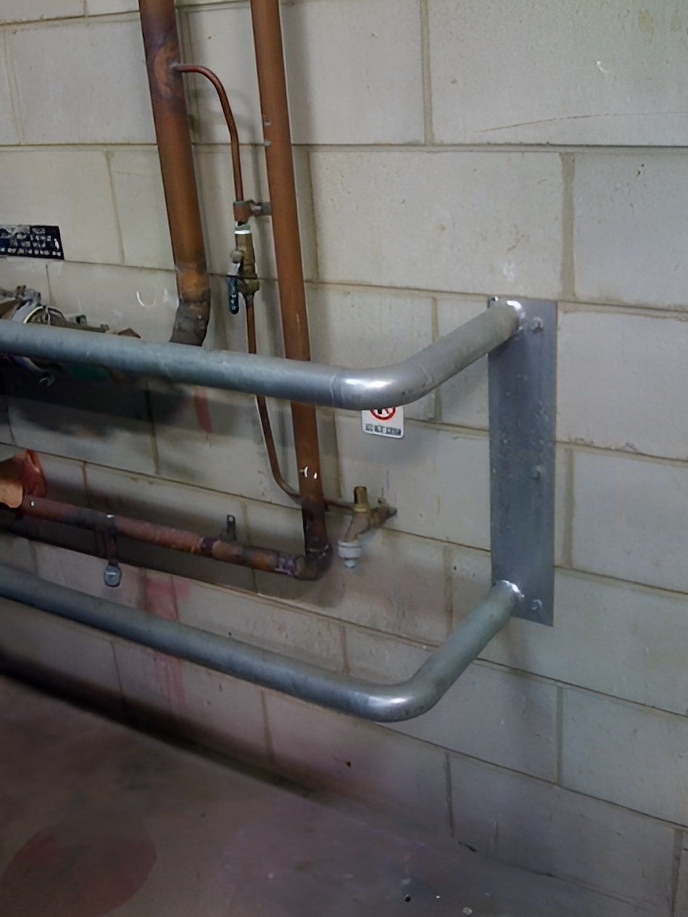 A Metal Railing is Attached to a Brick Wall — Metaltrendz in Kunda Park, QLD